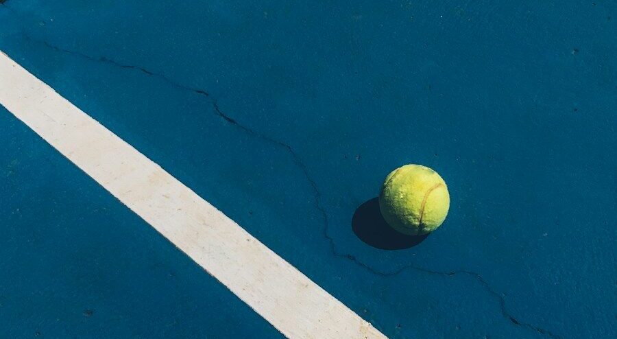 yellow tennis ball on court