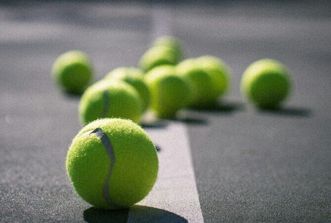 green tennis ball on gray concrete floor